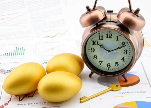 Three golden eggs and a golden key with a clock on business and financial reports : Key success in sustainable growth investment concept