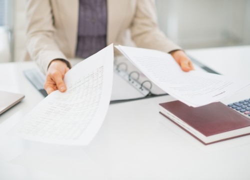 Closeup on clueless business woman with documents